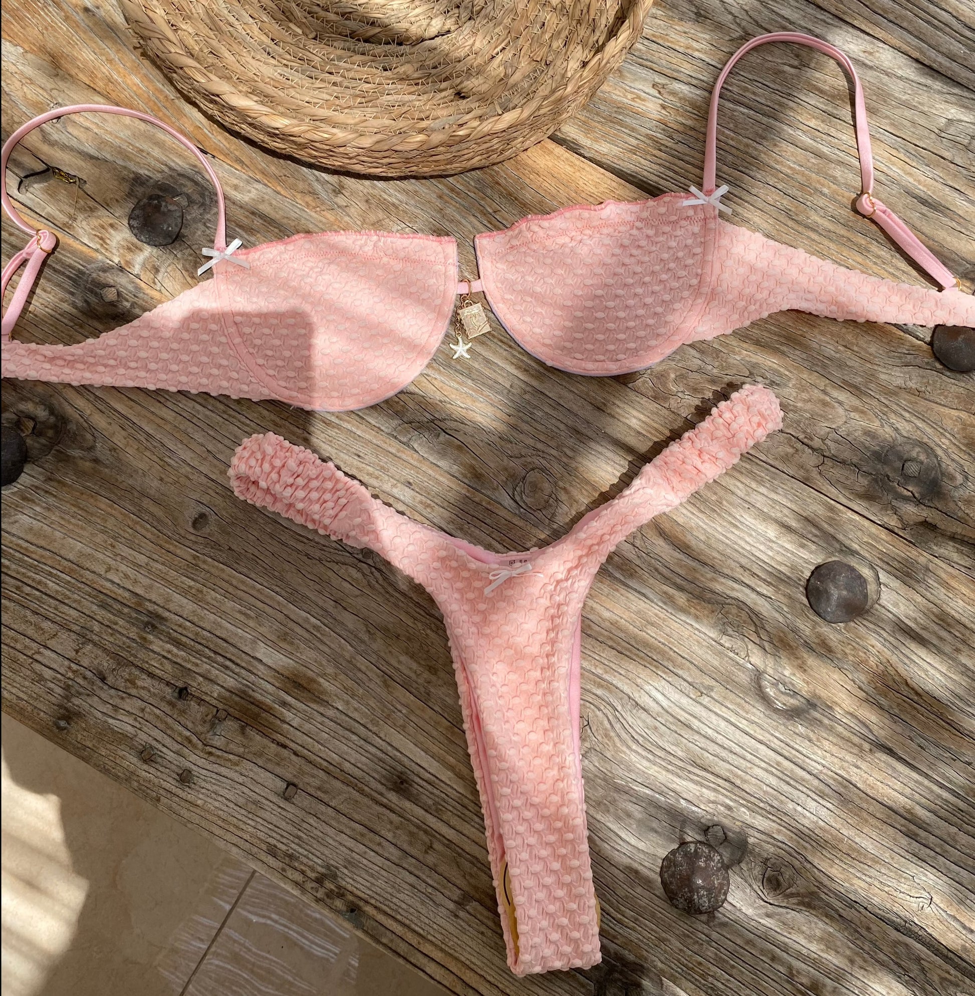Emilia Pink Textured Thong Bikini Bottom on gorgeous model - flat lay