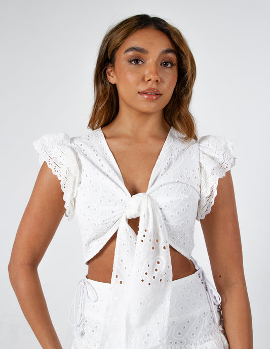 Delilah Embroidery Broderie Anglaise Tie up Crop Top in White on gorgeous model - front