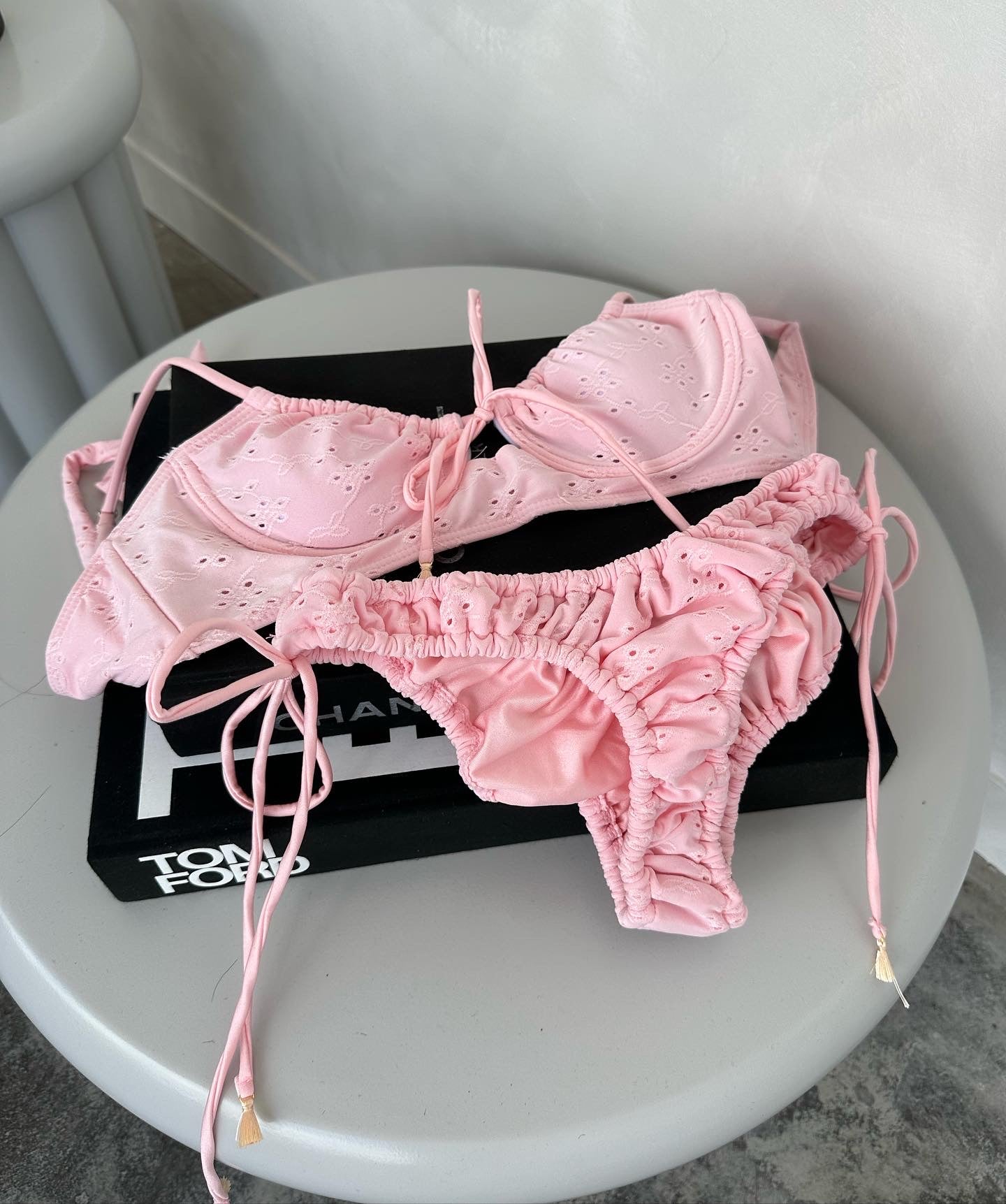 Dolly Pink Broderie Anglaise Textured Bikini Bottom on gorgeous model - flat lay on designer book