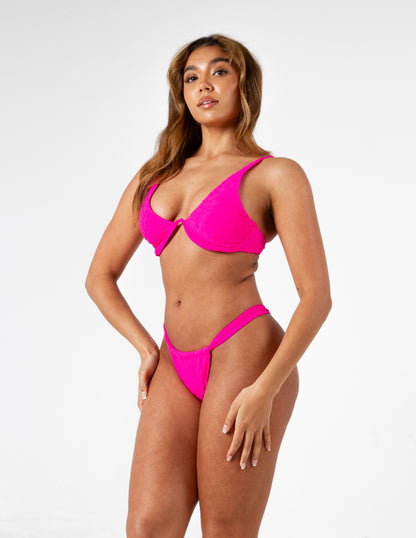 Neon pink leopard print textured padded boned bikini top with adjustable straps on gorgeous model - right side