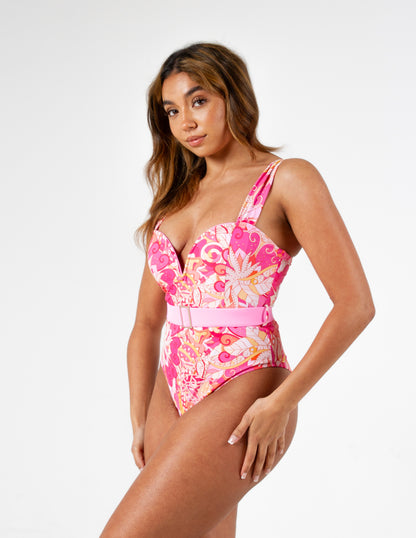 Figure-enhancing pink printed swimsuit with waist-cinching belt and sweetheart v neck padded cup design on our beautiful model. Right side